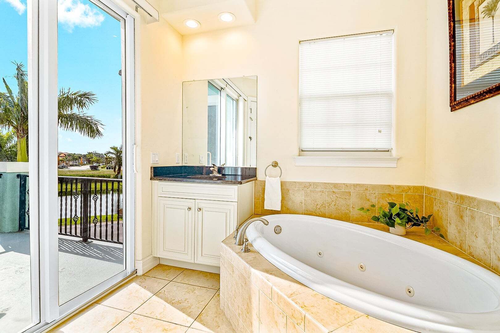 A bathroom with a bathtub, a sink, a mirror, and a window.