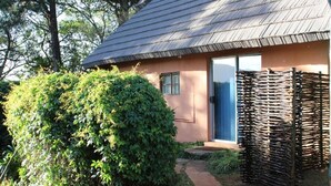 A small, single-story building with a sloped roof, a door, and a window.