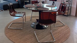 A modern living room with a round glass table, red chairs, and a ceiling light fixture. - Serenity Now / Spa+Outdoor Shower+Hammocks+RV h/up (Landers)