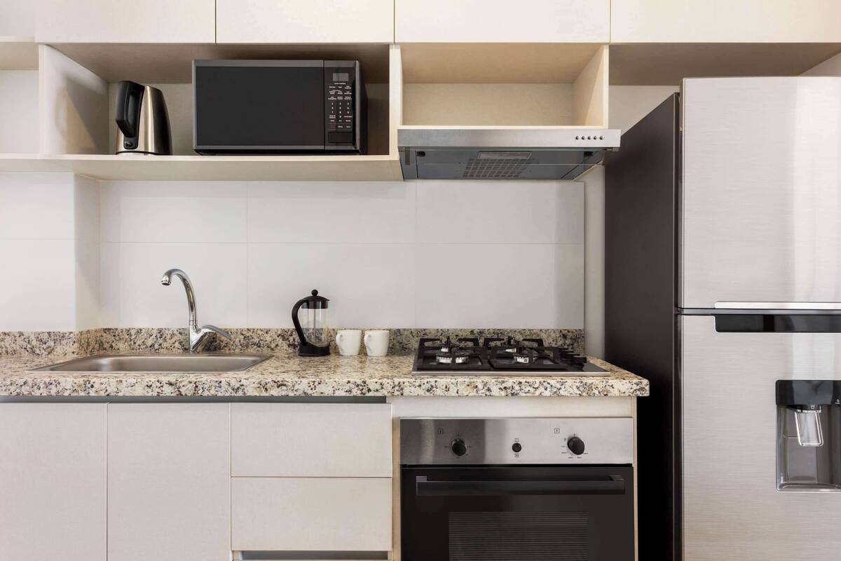 economy studio, 1 king bed, kitchen | private kitchen | full-sized fridge, microwave, oven, dishwasher