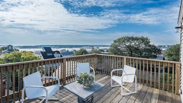 Enjoy the city view from this deck with a table and chairs, surrounded by a railing.