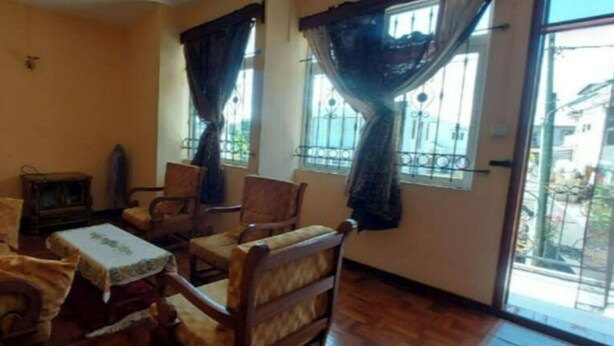 A living room with a sofa, chairs, a small table, and a television. - Villa Floreal 5 (floreal)