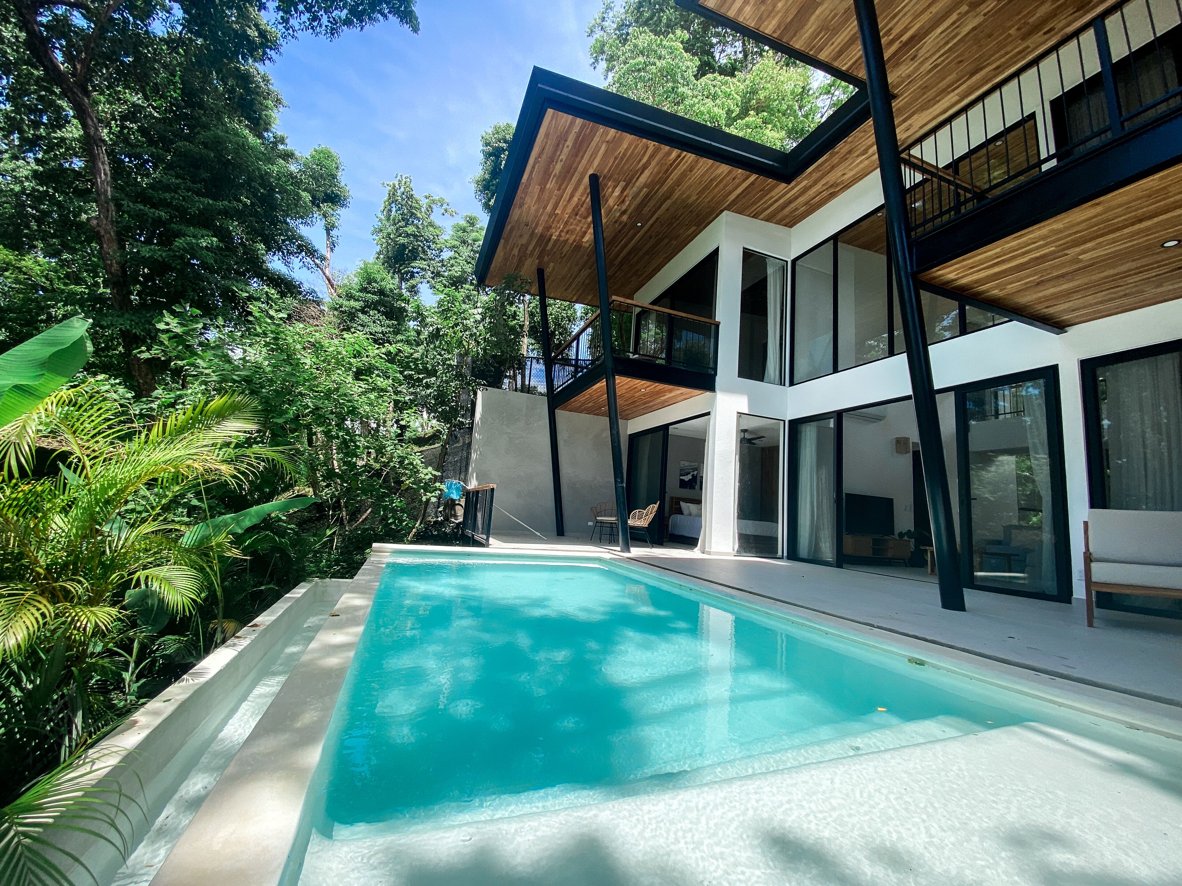 Una moderna casa con piscina immersa nel verde.