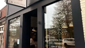 A storefront with a sign reading "LB KITCHEN" and a window display advertising "MORNING THINGS COFFEE LUNCH BOWLS". - Modern & Sunny House Steps from the Promenade. Private Parking! (Portland)