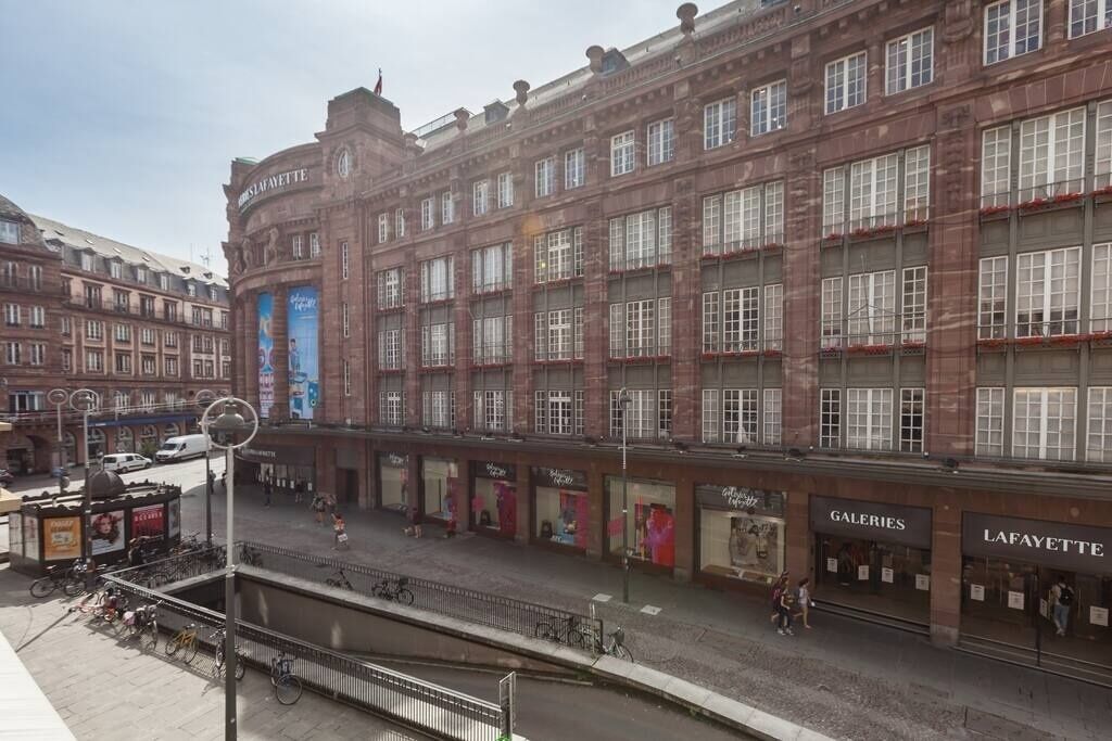A historic building with multiple storefronts, including 'GALERIES' and 'LAFAYETTE'.
