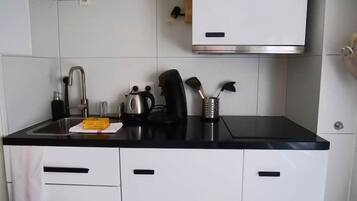 Fridge, coffee/tea maker, cookware/dishes/utensils, dining tables