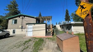 A residential area with a house, a garage, and a 'Children at Play' sign. - 305 2bd Lower · Moose 2 bedroom lower, close to downtown (Fairbanks)