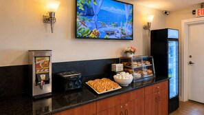 A breakfast buffet with waffles, a toaster, and a refrigerator. - The Boston Hotel  (Boston)