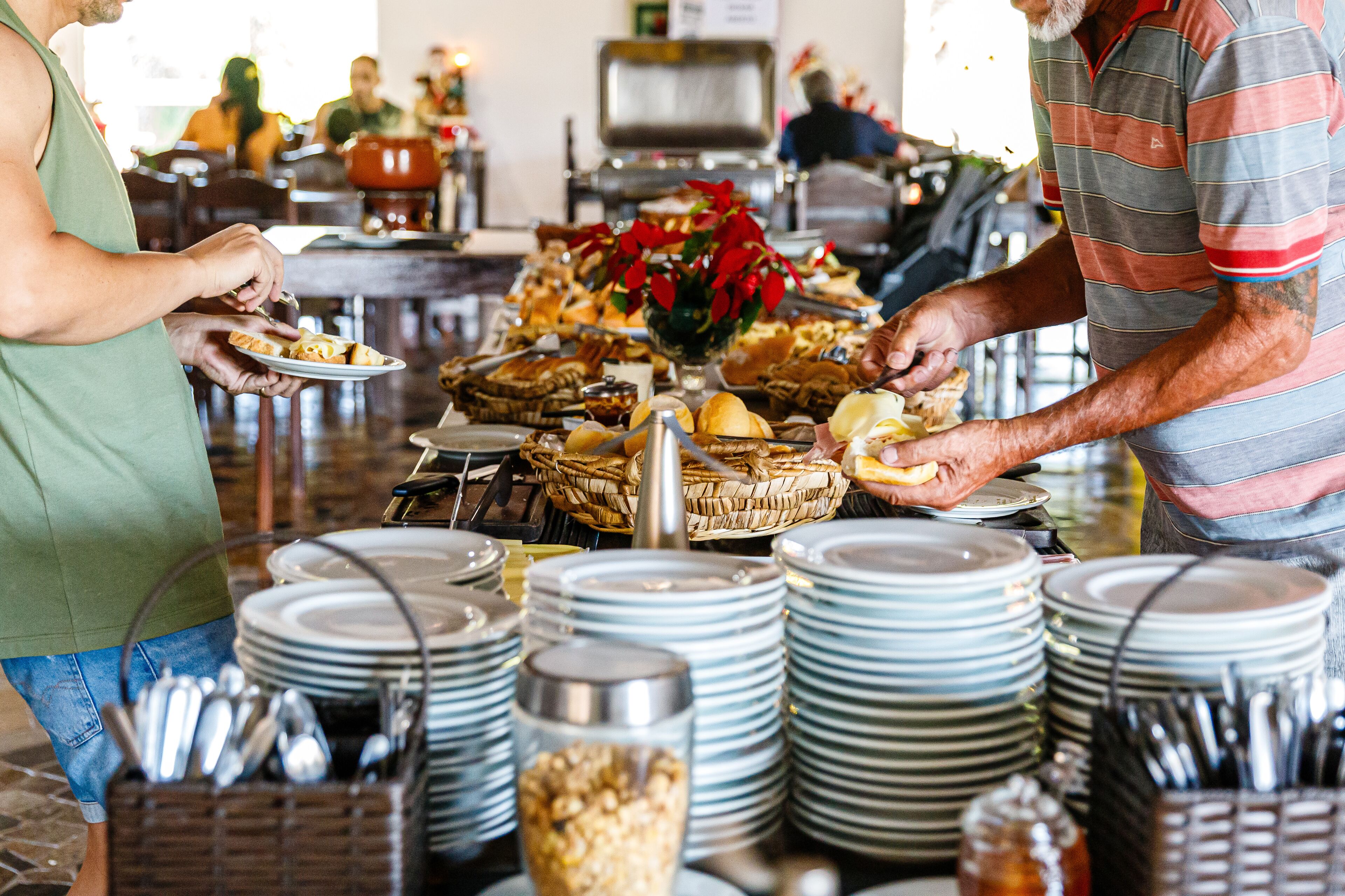 A buffet setup with various food items and stacked plates.