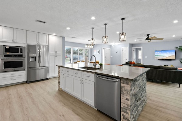 Full remodeled kitchen fully stocked with an amazing island, breakfast bar seating and open floor plan. Tons of storage.