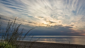A beach with a clear sky and calm sea.