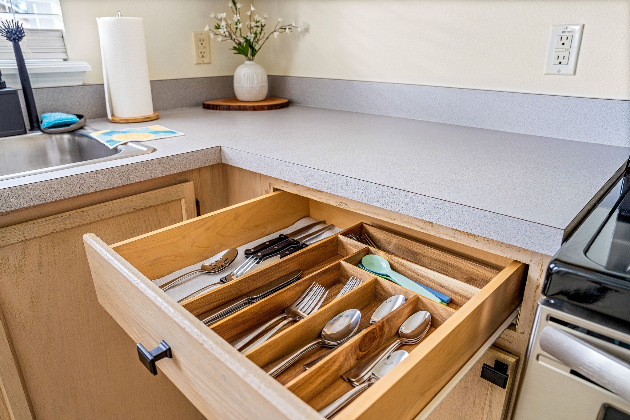 A kitchen drawer with utensils neatly organized.
