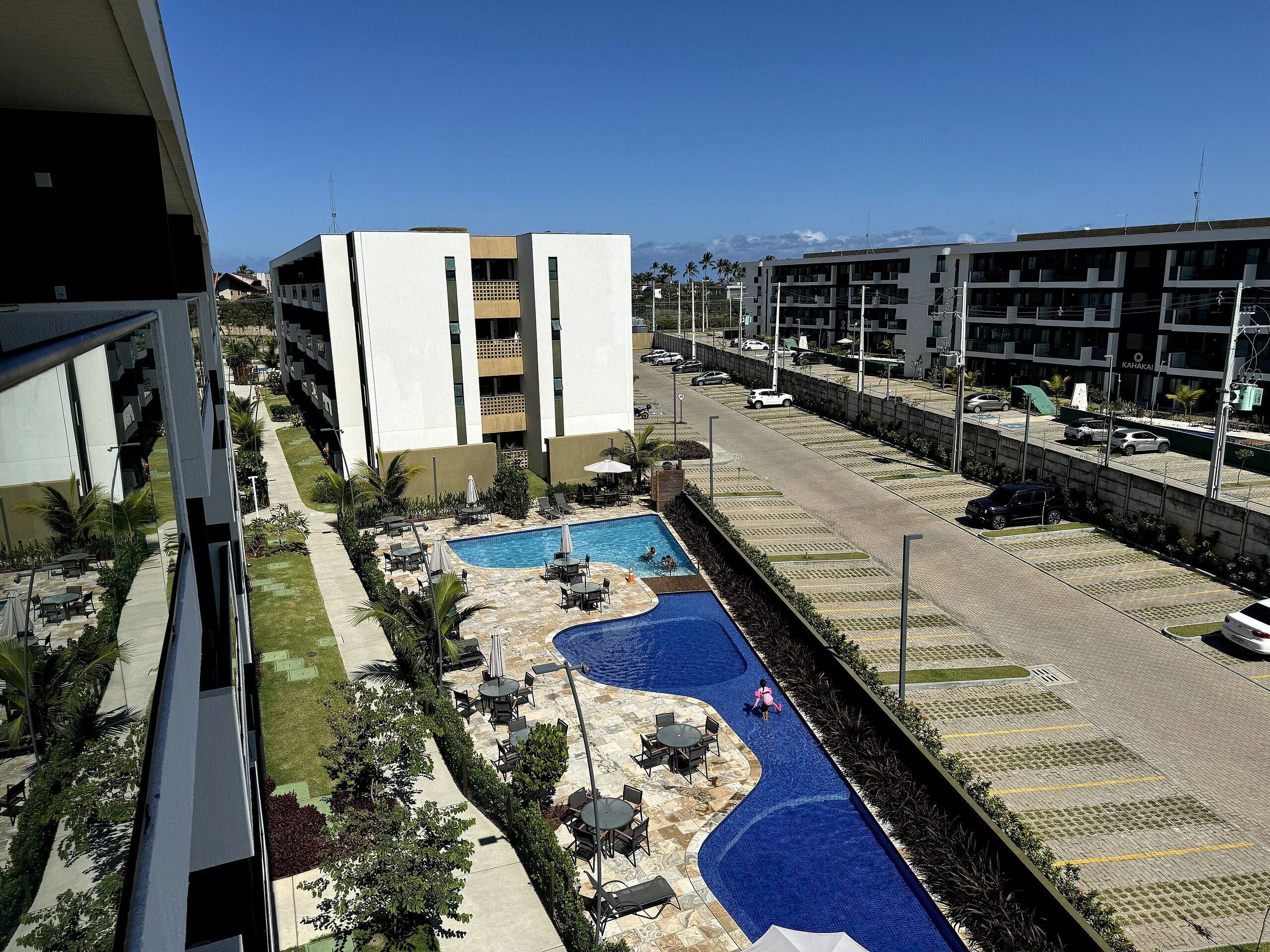 Un hotel con piscina, zona de estar al aire libre y vistas a la calle.