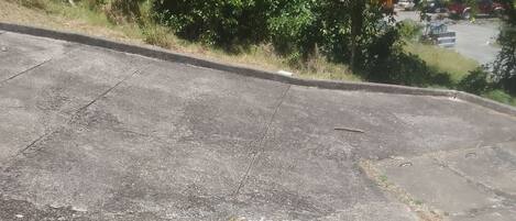 A concrete surface with visible cracks and patches.