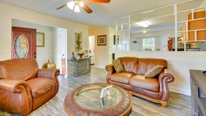 A spacious living room with leather sofas, a coffee table, and a ceiling fan. - Central High Point Home < 1 Mi to Downtown! (High Point)