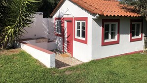 A small house with a red-tiled roof, white walls, and red-framed windows. - Lisbon Cozy House w/Garden and Pool (Barcarena)