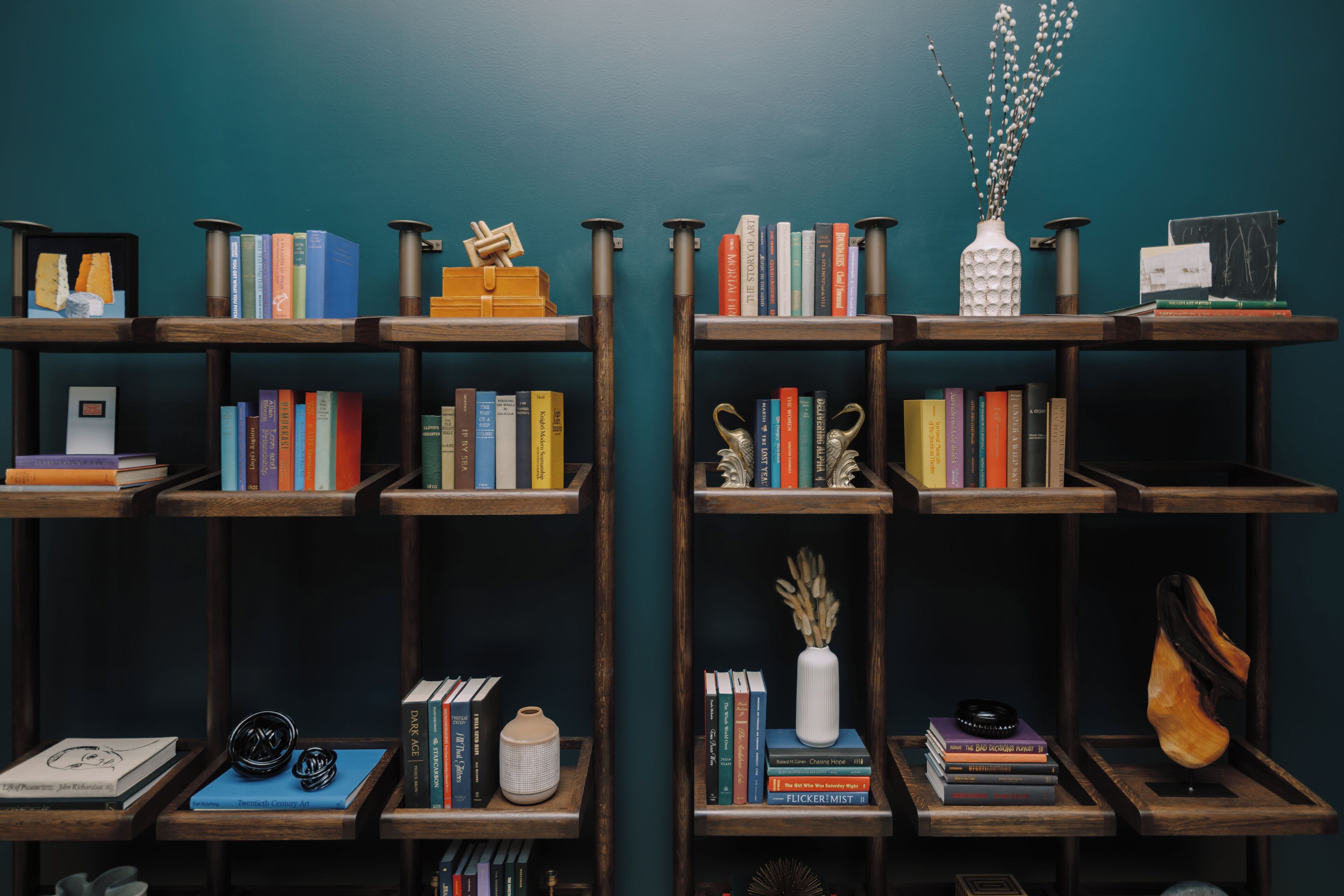 A bookshelf with various books and decorative items.