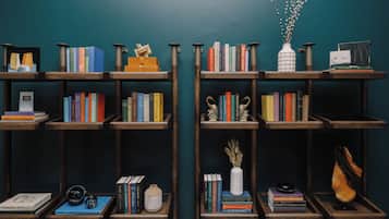 A bookshelf with various books and decorative items.
