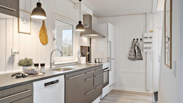 A modern kitchen with white cabinetry, a dishwasher, a sink, and pendant lights. - Amazing home in Haderslev with WiFi (Haderslev)