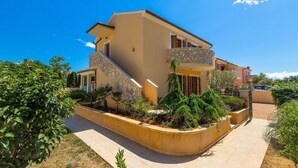 A two-story building with a stone staircase leading to a balcony. - Beautiful home in Marcana (Marcana)