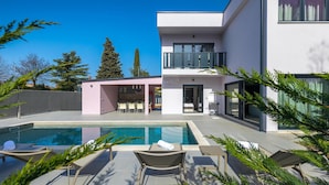 A modern two-story house with a swimming pool, outdoor seating, and a covered patio. - Amazing home in Porec (Porec)