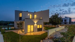 A modern two-story house with a balcony, large windows, and a well-maintained lawn. - Pet friendly home in Porec (Porec)
