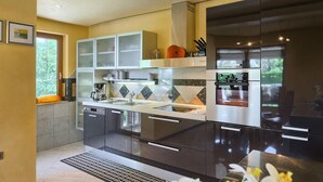 A modern kitchen with a built-in oven, a coffee maker, and a sink. - Nice home in Labin - Rabac (Labin - Rabac)