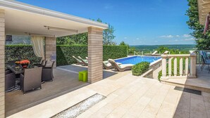 A covered outdoor area with a pool, lounge chairs, and a view of the landscape. - Nice home in Labin - Rabac (Labin - Rabac)
