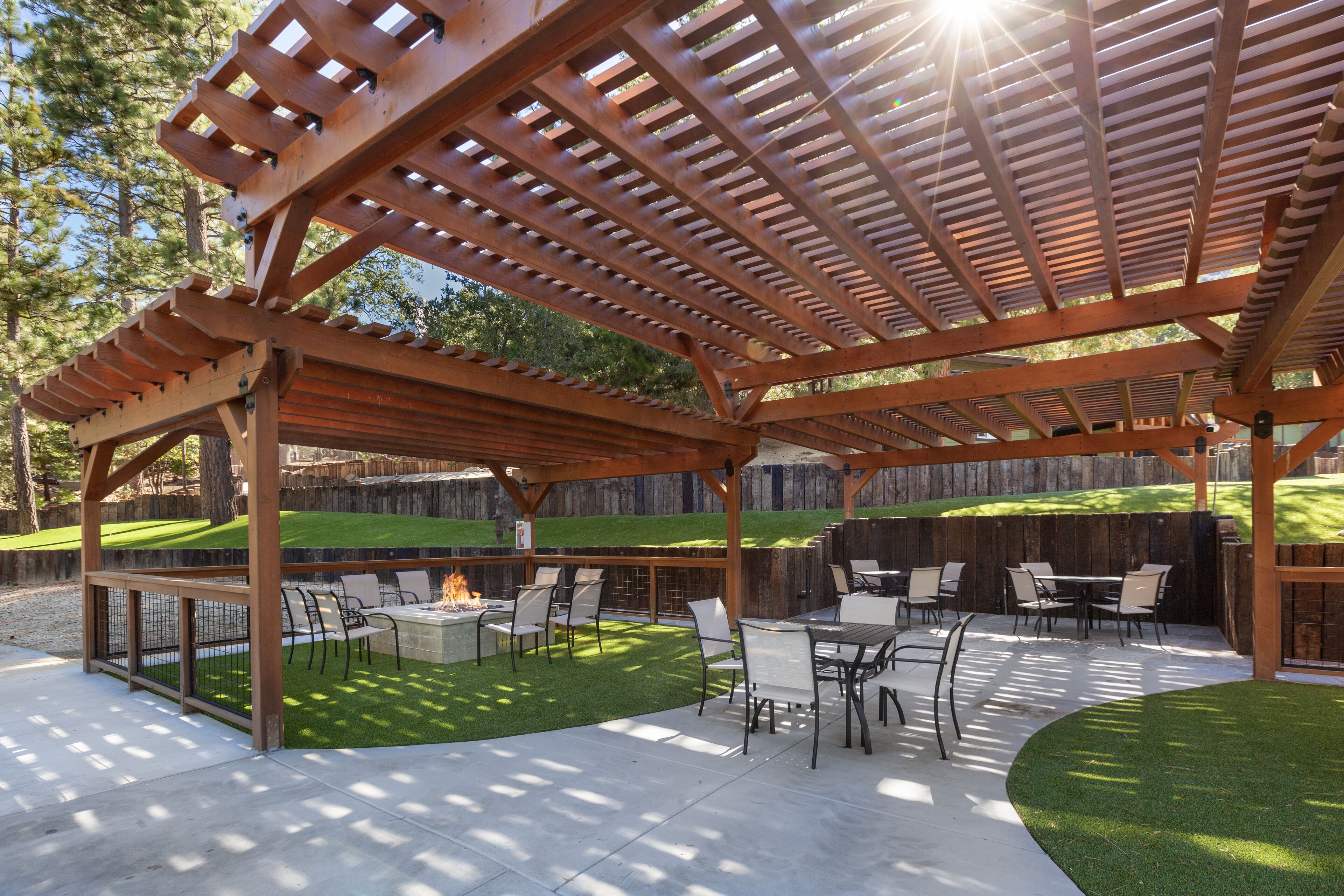 A covered patio area with outdoor furniture and a fire pit.
