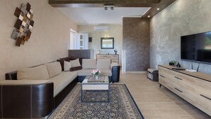 A modern living room with a sofa, coffee table, and TV. - Stunning home in Pula (Pula)