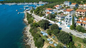 An aerial view of a coastal town with a marina, modern buildings, and a playground. - Beautiful home in Pula (Pula)