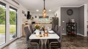 A modern kitchen with a dining area.