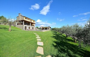 Stroll through the beautifully manicured lawn to the entrance of this charming country house.