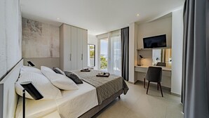 A modern bedroom with a bed, a desk, and a TV. - Lovely home in Blato with sauna (Blato)