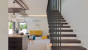 A modern interior with a staircase, a kitchen area, and a living space. - Amazing home in Barban (Barban)
