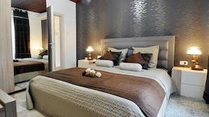 A modern bedroom with a large bed, two bedside tables, and a mirror.