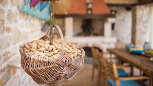 A wicker basket filled with almonds hanging from a chain.