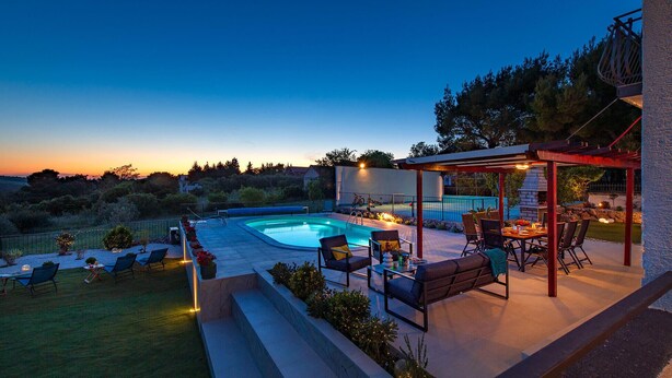A backyard with a swimming pool, outdoor seating, and a stone fireplace. - Stunning home in Sibenik (Sibenik)