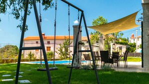A patio with a swing set, outdoor furniture, and a pool. - Gorgeous home in Porec (Porec)