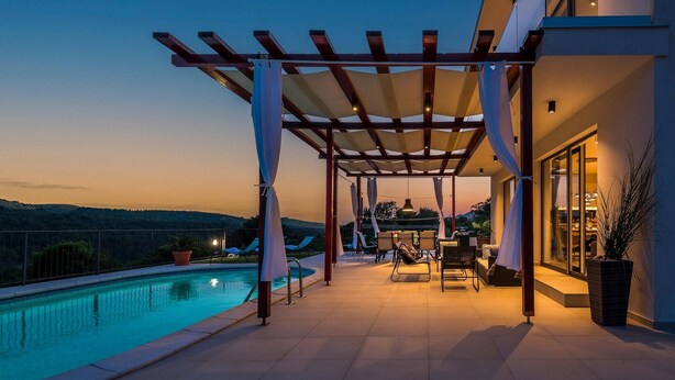 A rooftop pool area with a pergola, lounge chairs, and a view of the landscape. - Pet friendly home in Sibenik (Sibenik)