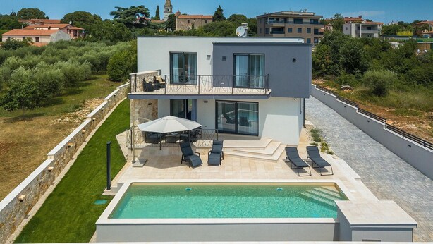 A modern two-story house with a swimming pool, outdoor seating, and a view of surrounding buildings. - Awesome home in Tar-Vabriga (Tar-Vabriga)