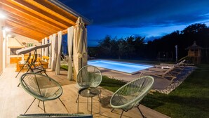 An outdoor patio with a pool, covered seating area, and lounge chairs. - Nice home in Visnjan with private swimming pool, can be inside or outside (Visnjan)