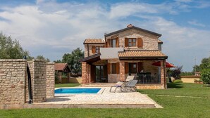 A two-story stone house with a swimming pool and outdoor seating. - Gorgeous home in Porec (Porec)