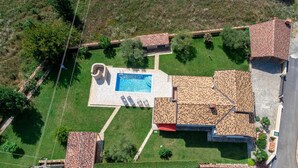 An aerial view of a property with a swimming pool, a stone patio, and a tiled roof. - Gorgeous home in Porec (Porec)