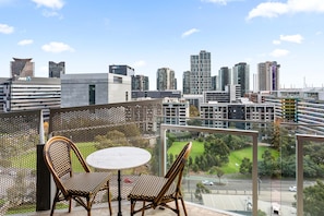 A balcony with a view of a cityscape, including high-rise buildings and a green park. - Watervue  in Docklands with City Views (Docklands)