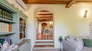 A cozy interior with a staircase leading to a dining area, a bookshelf, and a seating area with a plant. - Awesome home in Labin - Rabac (Labin - Rabac)