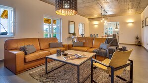 A modern living room with a leather sofa, a coffee table, and a patterned rug. - Lovely home in Opatija (Opatija)