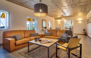 Relax in a cozy seating area with a leather sofa and armchair, complemented by a coffee table.