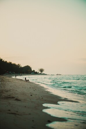 Enjoy a serene beach experience with a wide, gently sloping shoreline.