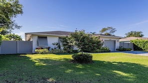 A single-story house with a front yard, a garage, and a mailbox. - Impeccably maintained Marco Island oasis! (Marco Island)